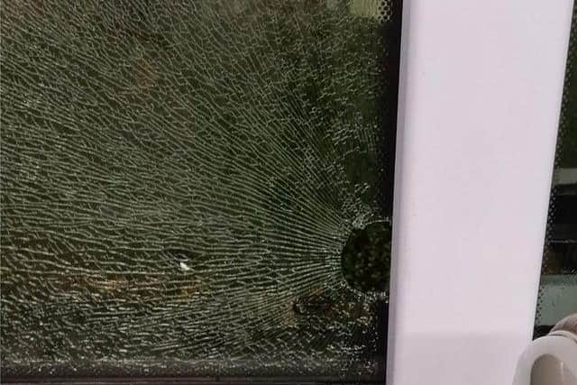 A smashed bus window caused by youths throwing bricks in a previous incident. Photo provided by First Bus