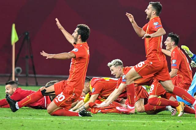 SETBACK: For Gjanni Alioski, centre, pictured celebrating North Macedonia's qualification to next year's Euros. Photo by VANO SHLAMOV/AFP via Getty Images.