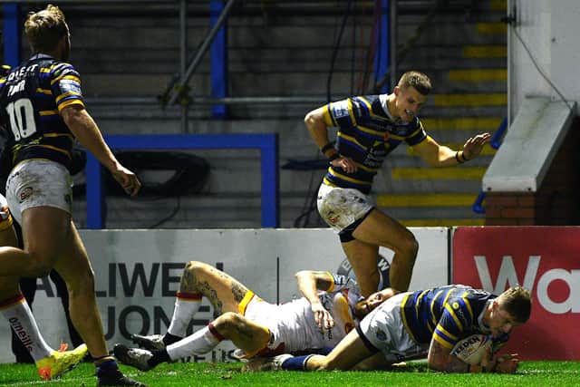Ash Handley begins to celebrate as Liam Sutcliffe touches down for Rhinos against Catalans. Picture by Jonathan Gawthorpe.