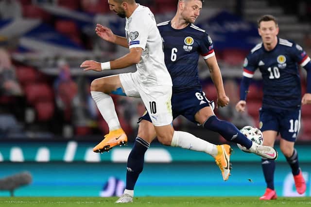 STARTING: Leeds United captain Liam Cooper, centre. Photo by ANDY BUCHANAN/AFP via Getty Images.