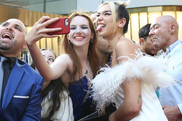 STAR: Dua Lipa, right, poses with fans on the red carpet ahead of the 33rd Annual ARIA Awards in Sydney, Australia last year. Photo by Lisa Maree Williams/Getty Images.