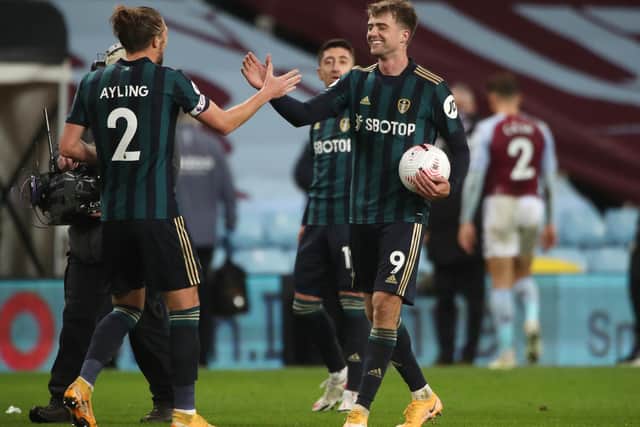 SIX APPEAL: Leeds United's Patrick Bamford walks off with the match ball and is congratulated by Luke Ayling after taking his tally for the first two months of the season to half a dozen with his Aston Villa treble. Photo by Nick Potts - Pool/Getty Images.