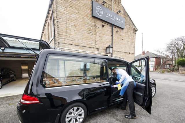 Funeral director Andrew Atkins wears PPE as he disinfects a hearse at Full Circle Funerals in Bramley, Leeds, who works alongside funeral director Sarah Jones, who is preparing for a second wave of Covid-related deaths.