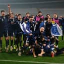 WAIT IS OVER: Leeds United captain Liam Cooper, back right, celebrates with the rest of the Scotland squad as the Tartan Army seal qualification for next year's Euros. Photo by Srdjan Stevanovic/Getty Images.