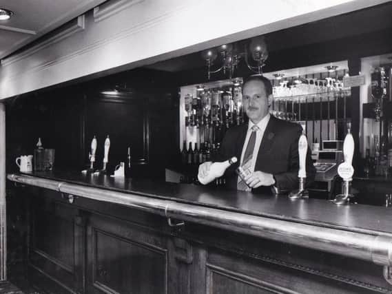 NOW YOU SEE IT: David Nicholas serves up a drink at the Wellesley Hotel's disappearing bar.