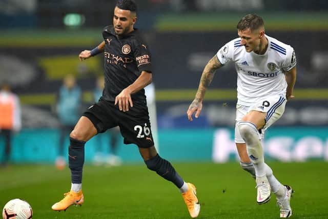 Leeds United captain Liam Cooper takes on Manchester City's Riyad Mahrez at Elland Road. (PA)
