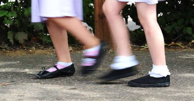File photo date 15/07/14 of school girls walking to school. Children under the age of 16 accounted for 1% of coronavirus cases in the first peak of Covid-19 in England, a new study has concluded.