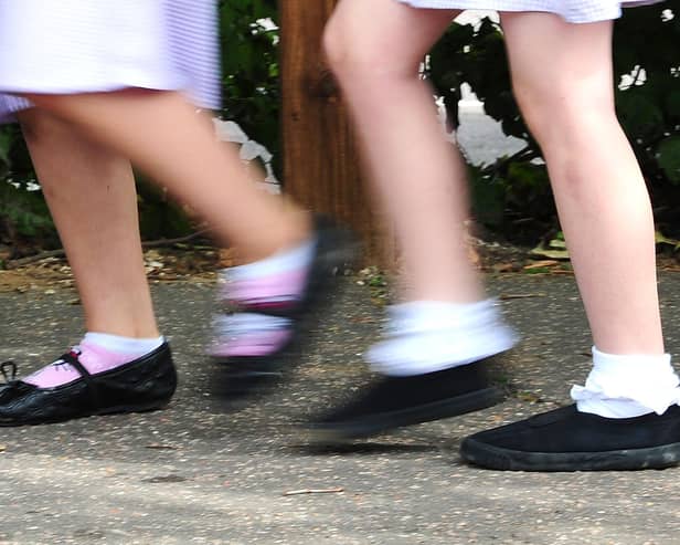 File photo date 15/07/14 of school girls walking to school. Children under the age of 16 accounted for 1% of coronavirus cases in the first peak of Covid-19 in England, a new study has concluded.