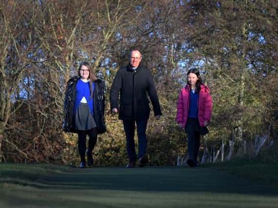 Staff and Pupils at Allerton Bywater Primary School   are doing a sponsored walk for MND foundation in honour of Rob Burrow.
Headteacher Richard Cairns is pictured with pupils Eadie Shaw (left) and Lillie Robinson.
Picture by Simon Hulme