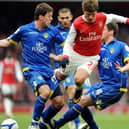 SO CLOSE: Leeds United defender Ben Parker, left, and Alex Bruce, right, sandwich Arsenal's Russian midfielder Andrey Arshavin during the third round FA Cup clash of January 2011. Photo by ADRIAN DENNIS/AFP via Getty Images.