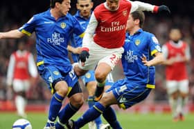 SO CLOSE: Leeds United defender Ben Parker, left, and Alex Bruce, right, sandwich Arsenal's Russian midfielder Andrey Arshavin during the third round FA Cup clash of January 2011. Photo by ADRIAN DENNIS/AFP via Getty Images.