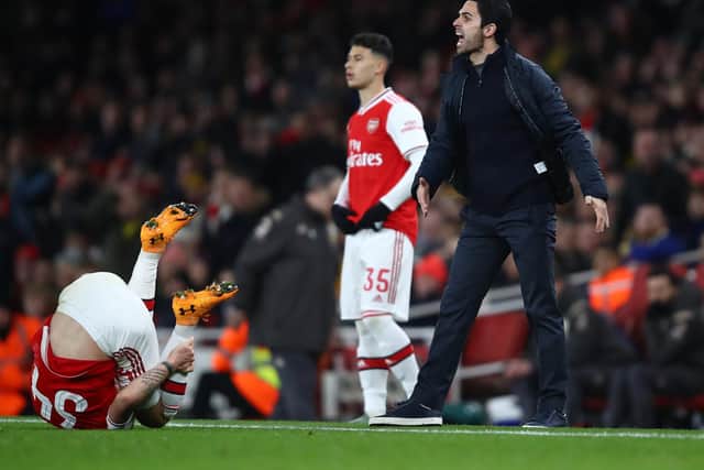 FIRST MEETING: Arsenal boss Mikel Arteta, right, reacts with Leeds United head coach Marcelo Bielsa in the background, left, as Granit Xhaka takes a tumble during January's FA Cup clash. Photo by Julian Finney/Getty Images.