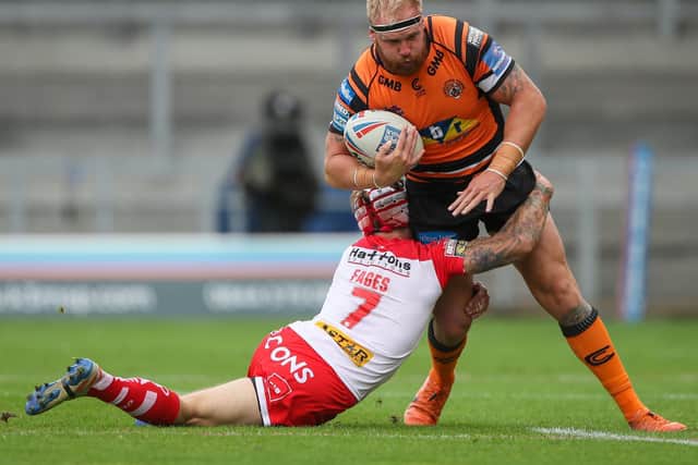 Oliver Holmes is tackled by St Helens' Theo Fages. Picture by Bruce Rollinson.