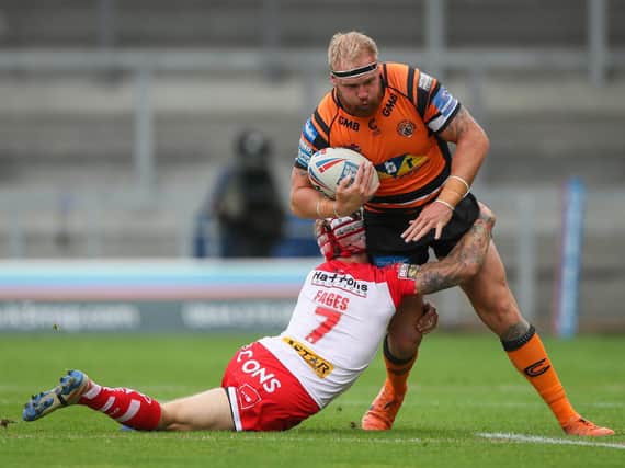 Oliver Holmes is tackled by St Helens' Theo Fages. Picture by Bruce Rollinson.