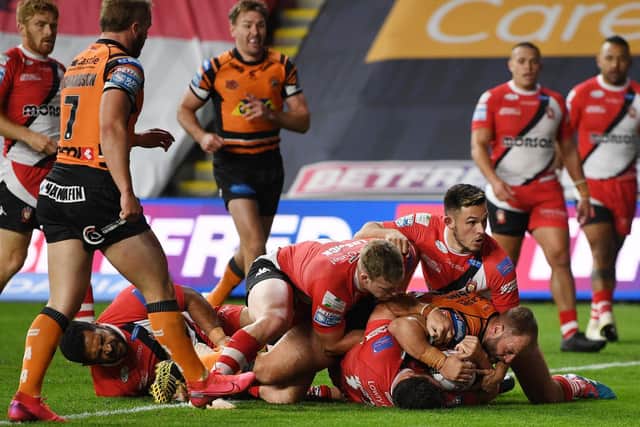 Paul McShane scores for Tigers against Salford in September. Picture by Jonathan Gawthorpe.