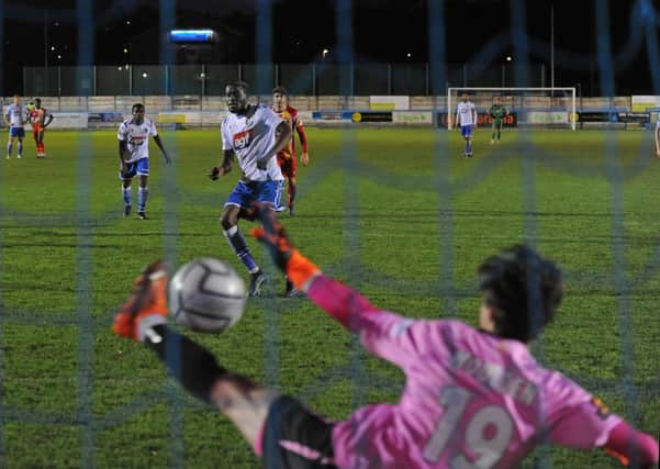 Guiseley's Lebrun Mbeka beats Gloucester goalkeeper Louie Moulden from the penalty spot but the Lions could not find an equaliser in a 2-1 defeat. Picture: Steve Riding.