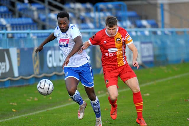 Isaac Currie of Guiseley takes on Alex Whittle of Gloucester City. Picture: Steve Riding.