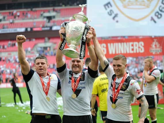 Gareth Ellis lifts the Challenge Cup in 2016, flanked by Hull coach Lee Radford and teammate Marc Sneyd. Picture by Jonathan Gawthorpe.