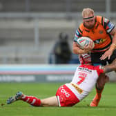 Castleford Tigers' Oliver Holmes is tackled by St Helens' Theo Fages. Picture: Alex Whitehead/SWpix.com.