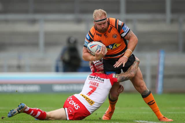 Castleford Tigers' Oliver Holmes is tackled by St Helens' Theo Fages. Picture: Alex Whitehead/SWpix.com.