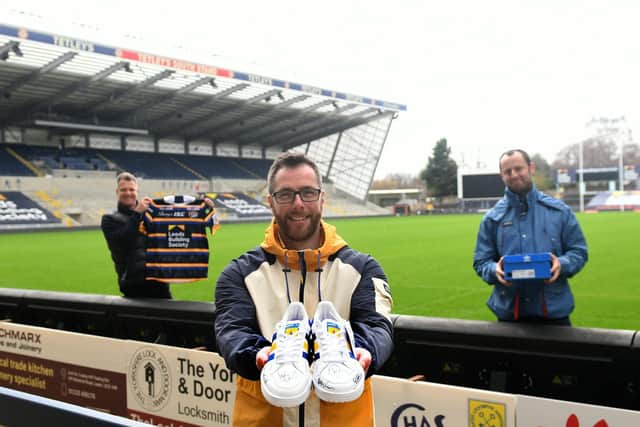 Craig Chapman (centre ) of The Pool with the unique customised Rob Burrow rrainers and Rob Oates from Leeds Rhinos with a signed Rhinos shirt (left) and David Mills, a fellow director The Pool (right).
Photo: Gary Longbottom.