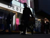 Pedestrians walk past a Debenhams department store in London on December 1, 2020, as non-essential retail prepares to re-open its doors to the public on December 2 following a second national lockdown to help stem the spread of the novel coronavirus. Photo by JUSTIN TALLIS/AFP via Getty Images)