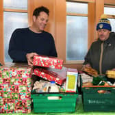 A group of Leeds United fans have helped launch an appeal to buy Christmas presents for children across south Leeds. The appeal called 'All Elves Aren't We' is an initiative between members of The Roaring Peacock podcast and Slung Low, based at the old Holbeck WMC.
Pictured Ewan Metcalfe (The Roaring Peacock), right, and Alan Lane (Slung Low artistic director).

Picture : Jonathan Gawthorpe