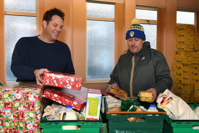 A group of Leeds United fans have helped launch an appeal to buy Christmas presents for children across south Leeds. The appeal called 'All Elves Aren't We' is an initiative between members of The Roaring Peacock podcast and Slung Low, based at the old Holbeck WMC.
Pictured Ewan Metcalfe (The Roaring Peacock), right, and Alan Lane (Slung Low artistic director).
Picture : Jonathan Gawthorpe