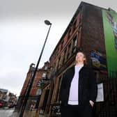 Artist Adam Duffield pictured with his Pablo Hernandez mural on the side of the Duck and Drake pub in the city centre. Picture by Simon Hulme.