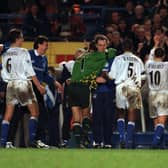 MAKING THEIR POINT: Leeds United applaud the visiting support after surviving an entire half with nine men to leave the 'Battle of the Bridge' against Chelsea of December 1997 with a 0-0 draw. Picture by Mark Bickerdike.
