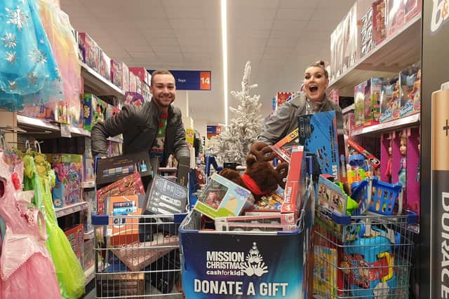 Pulse 1 Breakfast show presenters Mylo and Rosie doing a trolley dash at B&M Hunslet for the Cash for Kids Mission Christmas appeal.