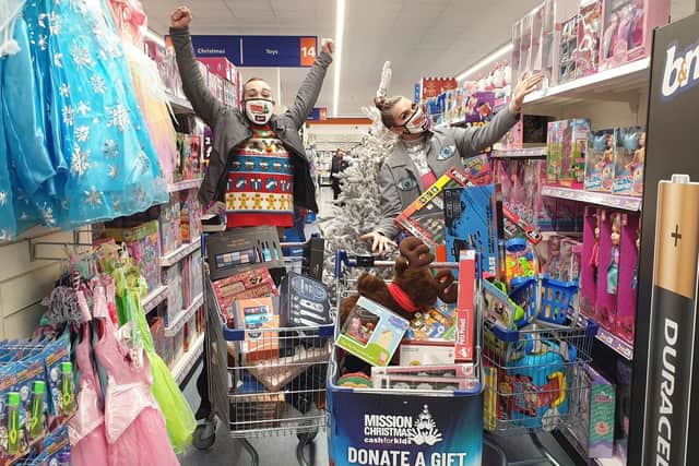 Pulse 1 Breakfast show presenters Mylo and Rosie doing a trolley dash at B&M Hunslet for the Cash for Kids Mission Christmas appeal.