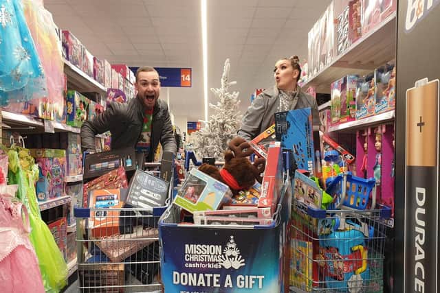 Pulse 1 Breakfast show presenters Mylo and Rosie doing a trolley dash at B&M Hunslet for the Cash for Kids Mission Christmas appeal.