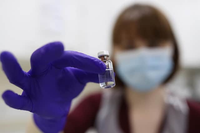 An NHS pharmacy technician at the Royal Free Hospital, London, simulates the preparation of the Pfizer vaccine to support staff training ahead of the rollout.