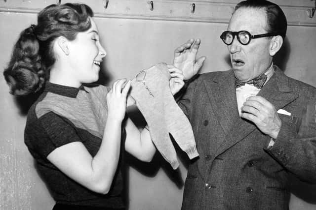 October 1955 and Arthur Askey registers amazement at the size of his garment after his daughter Anthea has shrunk it in the wash. The Askey's were appearing in The Love Match at The Empire.