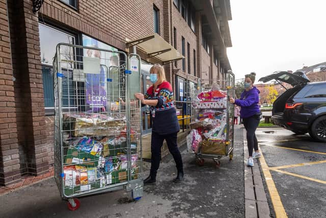 Pictured are Lisa Beaumont, play manger at Leeds Children's Hospital along with Helen Stella-McDonald, fundraiser for Leeds Cares unloading the Christmas hampers.