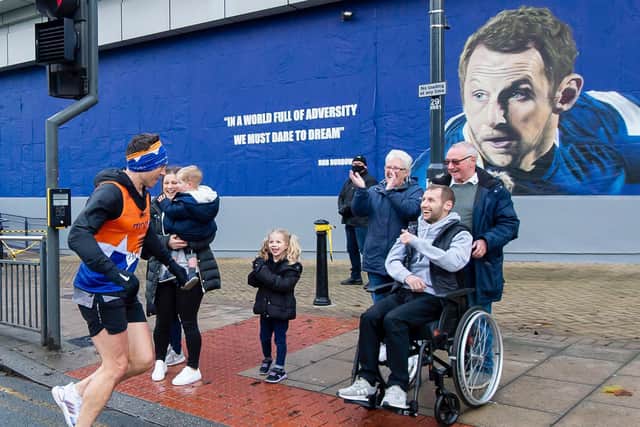 ENCOURAGEMENT: Kevin Sinfield is greeted by Rob Burrow during his fifth marathon on Saturday. Picture: Allan McKenzie/SWpix.com.