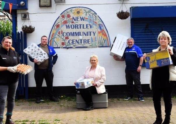 New Wortley Community Association staff and volunteers, including CEO Andrea Edwards, seated, outside its  Wellbeing Centre.