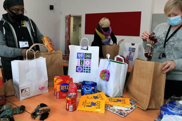 Members of staff from Space 2 prepare Christmas gift boxes and hampers to be handed out to families in east and north east Leeds at The Old Fire Station in Gipton.
From left, Aulson Lawrence, Jane Morland and Tara Scott.

Picture : Jonathan Gawthorpe