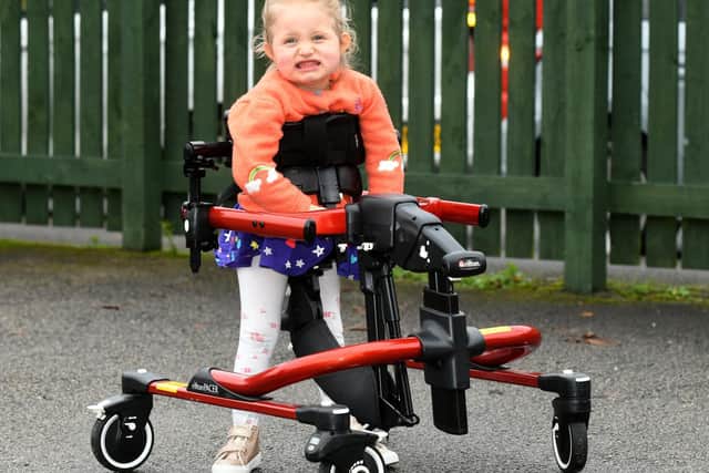 Tilly West pictured in a £3,500 walker that gives her the ability to stand upright.