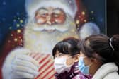 People walk past a Christmas display in a shop window in Leeds in November. Picture: Danny Lawon/PA Wire