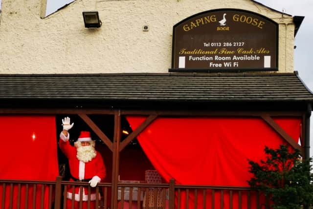 Santa waving to children at the drive-thru Santa experience at the Gaping Goose in Garforth.