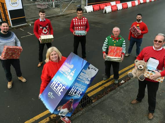 Pulse 1 radio station charity manager Lisa Sullivan with staff from Esh Construction, who have raised £5,000 and bought presents, for this year's Pulse 1 Mission Christmas appeal.

Picture : Jonathan Gawthorpe