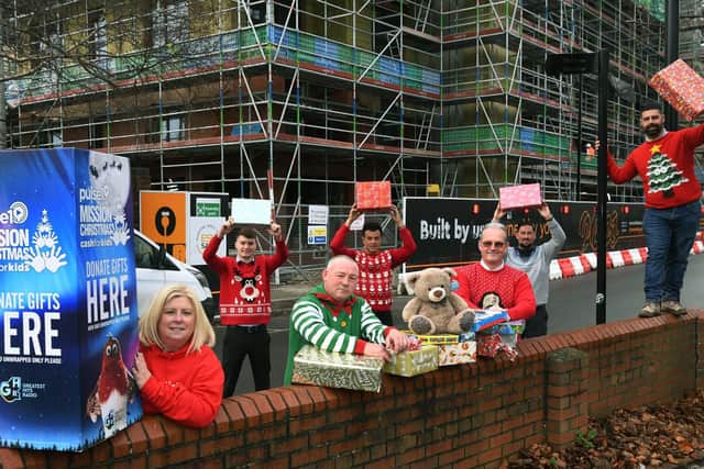 Pulse 1 radio station charity manager Lisa Sullivan with staff from Esh Construction, who have raised £5,000 and bought presents, for this year's Pulse 1 Mission Christmas appeal.

Picture : Jonathan Gawthorpe