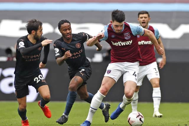 West Ham United's Declan Rice, right, battles for the ball with Manchester City's Raheem Sterling, centre, and Bernardo Silva. Picture: Paul Childs/PA Wire.