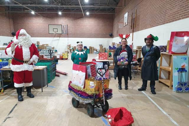From left to right: Santa with volunteers Brenda Barlow, Samantha Gilmore and Badger Nimahson. They were helped by fifth volunteer Andrew Haigh
