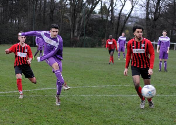 Alex Diaz scores the third goal in Leeds Medics & Dentists' 4-2 win over Lower Hopton. Picture: Steve Riding.