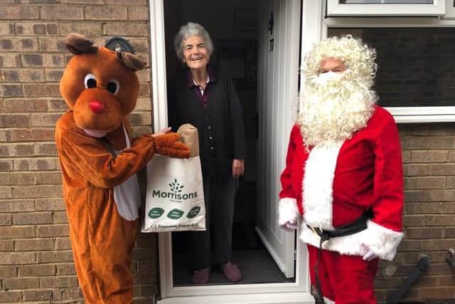 One resident in Kirkstall receives her Christmas diner from Rudolph and Father Christmas.