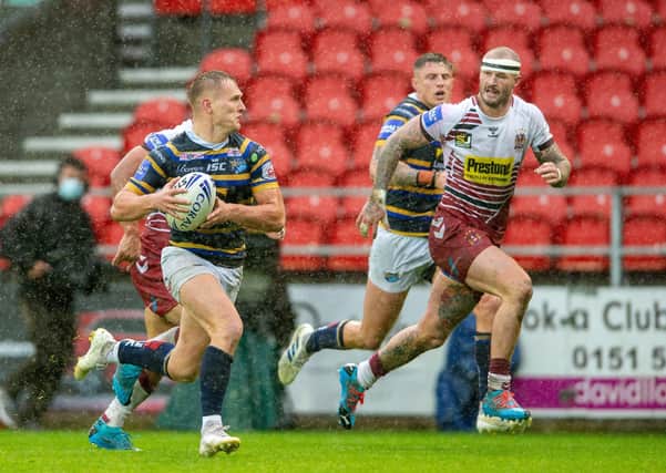 PLAYER OF THE SEASON: Leeds Rhinos' Brad Dwyer chased by Wigan's Zak Hardaker during the Challenge Cup semi final. Picture: Bruce Rollinson