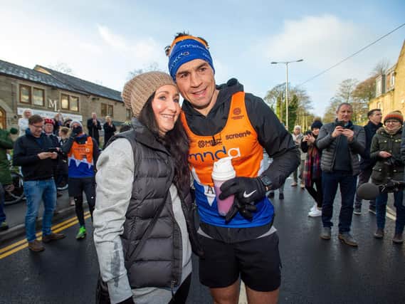 Kevin Sinfield is congratulated by his wife, Jayne, after his seventh marathon in as many days. Picture by Bruce Rollinson.